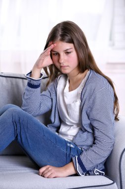 Kanepede oturan üzgün kız 