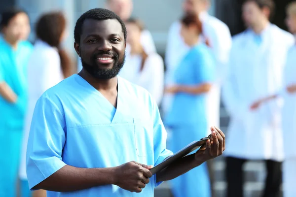 Handsome Smiling Doctor Clipboard Hands Standing Group Medical Workers — Stock Photo, Image