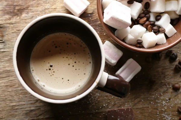 Cup of coffee with sweets on wooden background — Stock Photo, Image