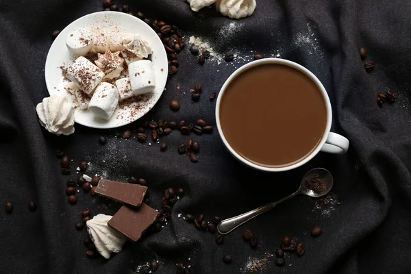 Cup of coffee with sweets on a black tablecloth — Stock Photo, Image