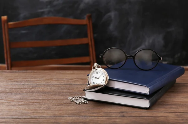 Notebooks, eyeglasses and vintage clock — Stock Photo, Image