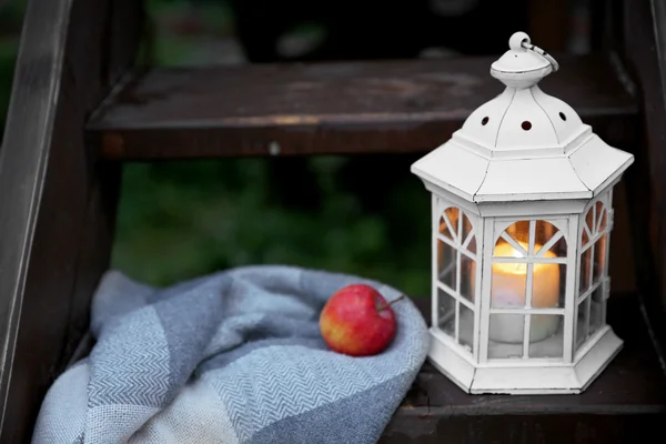 Lantern with candle on wooden stairs — Stock Photo, Image