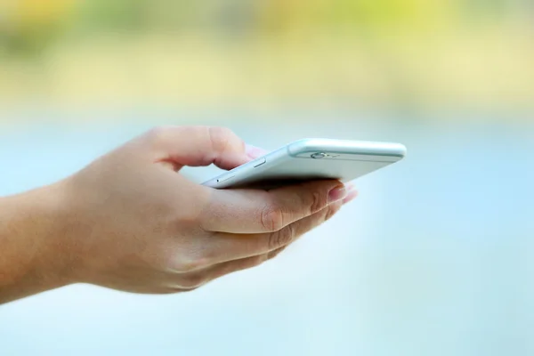 Hand hält ein Mobiltelefon — Stockfoto