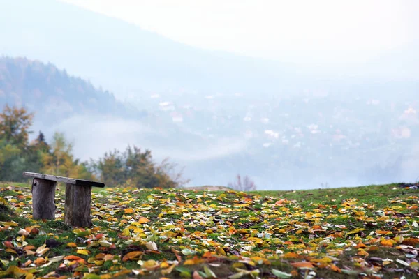 Wooden bench in mountains — Stock Photo, Image