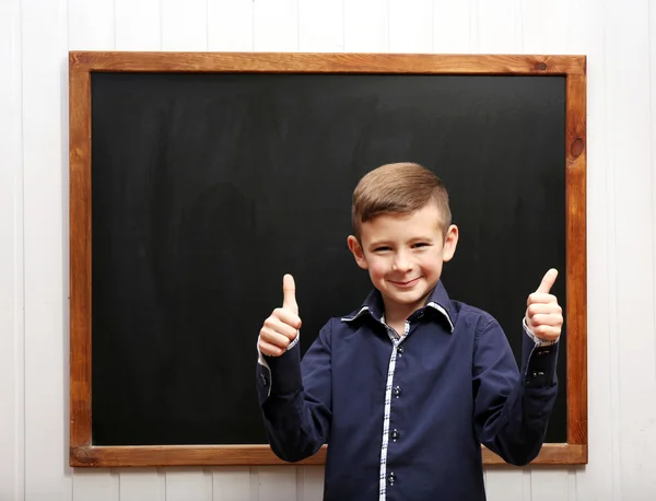 Cute boy posing at clean blackboard Royalty Free Stock Images