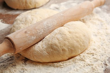 Dough for pizza and rolling-pin clipart