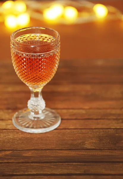 A glass of pink wine on wooden table background — Stock Photo, Image