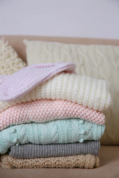 Knitted clothes on sofa — Stock Photo, Image