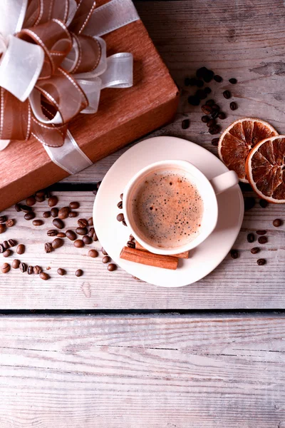 Beautiful gift, cup with coffee and coffee grains