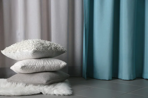 Multicoloured pillows on a carpet — Stock Photo, Image