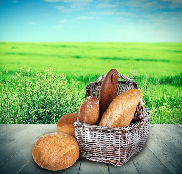 Fresh bread on wooden table — Stock Photo, Image