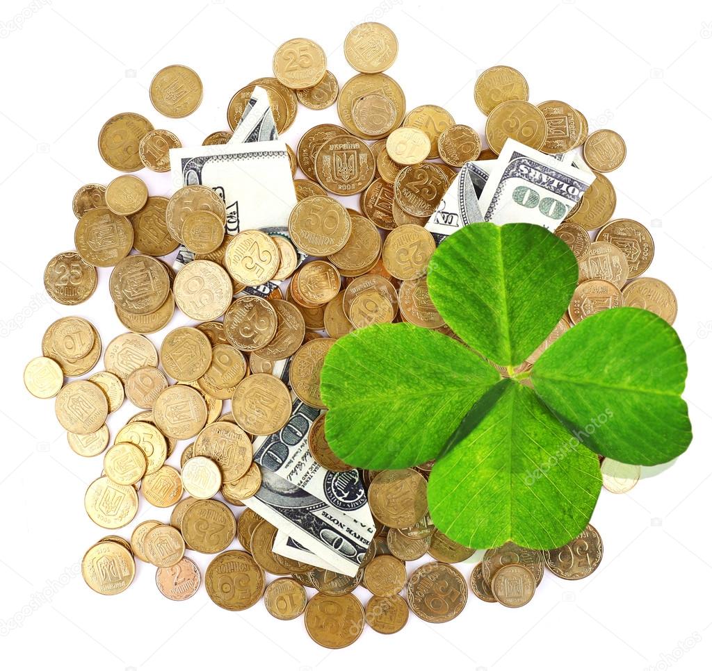 Clover leaf, golden coins and dollars