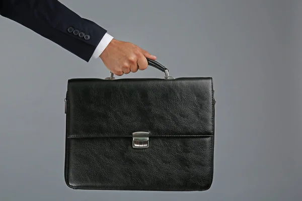 Male hand holding briefcase — Stock Photo, Image