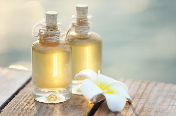 Bottles of aroma oil with flower — Stock Photo, Image