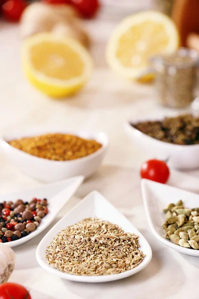 Variety of spices in ceramic containers on the kitchen table — Stock Photo, Image