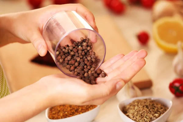 Allspice in the jar and variety of spices on the kitchen table — Stock Photo, Image