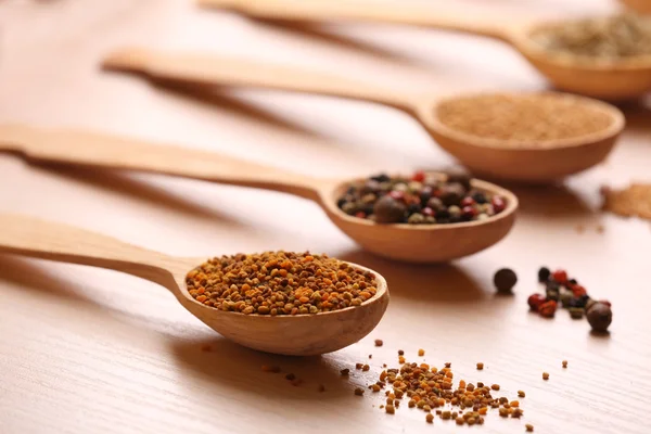 Variety of spices in spoons on the kitchen table — Stock Photo, Image