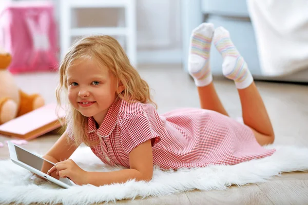 Little girl with tablet — Stock Photo, Image