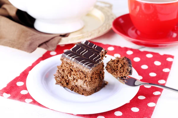 Served table with chocolate cakes and a cup of tea on red dotted background — Stock Photo, Image