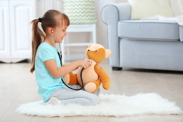 Girl with stethoscope and bear — Stock Photo, Image