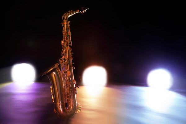 Beautiful golden saxophone on a scene