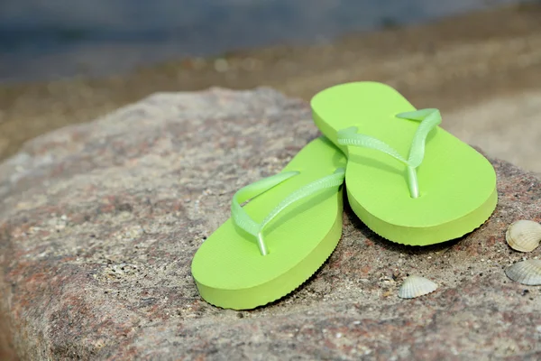 Bright flip-flops on stone — Stock Photo, Image