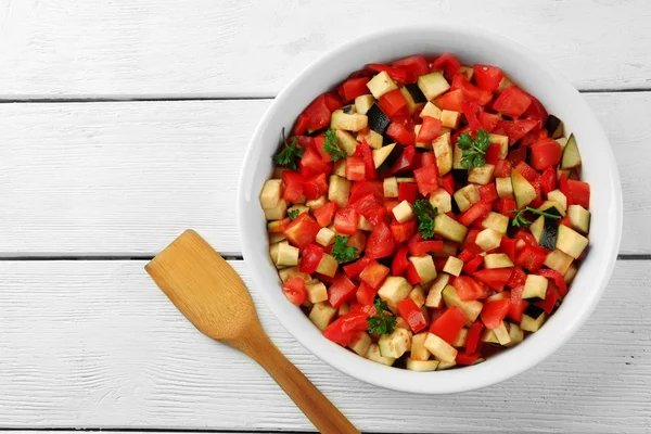 Ratatouille, stewed vegetable dish with tomatoes, zucchini, eggplant before cooking, on wooden background — Stock Photo, Image