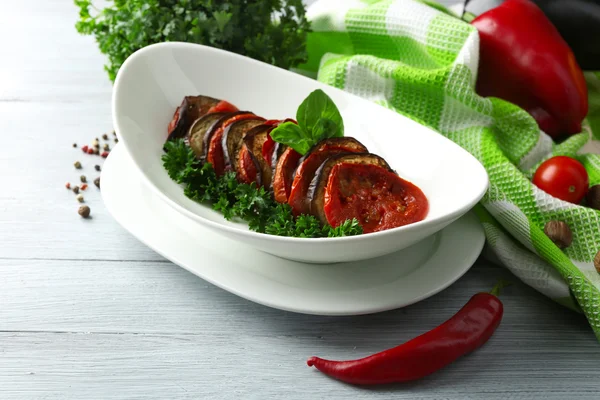 Ratatouille in bowl, on wooden table background — Stock Photo, Image