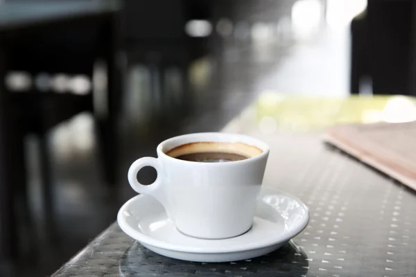 Tasse leckeren Kaffee und Zeitungen im Café — Stockfoto