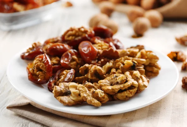 Walnut and date fruit in plate — Stock Photo, Image