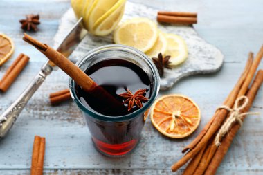Lezzetli mulled şarap ve baharat, mavi ahşap arka plan üzerinde yakın çekim