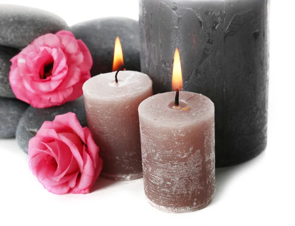 Candele aromatiche con ciottoli e fiori isolati su sfondo bianco — Foto Stock