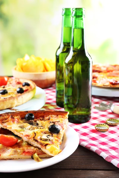 Sliced pizza served with beer — Stock Photo, Image