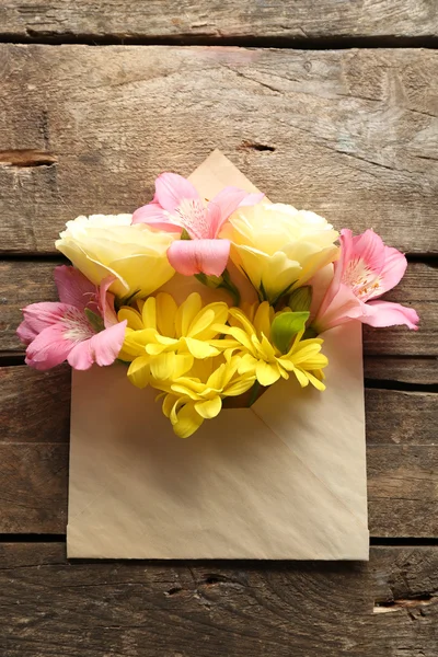 Fresh bouquet of flowers in envelope — Stock Photo, Image