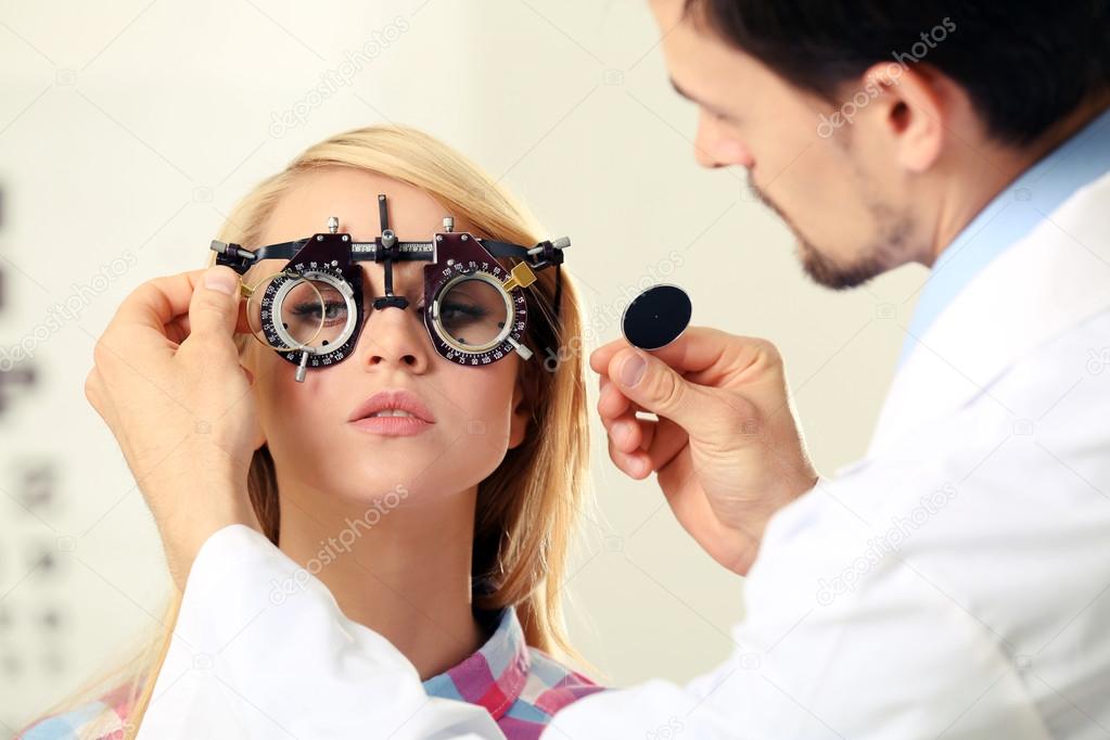 Male doctor examing female patient