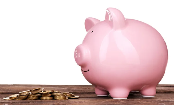Piggy bank and pile of coins — Stock Photo, Image