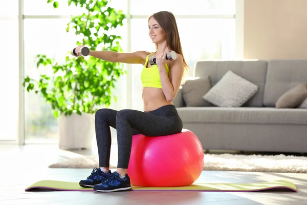 Girl doing exercises with dumbbells — Stock Photo, Image
