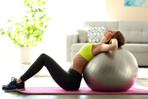 Girl doing exercises with fit ball Stock Photo