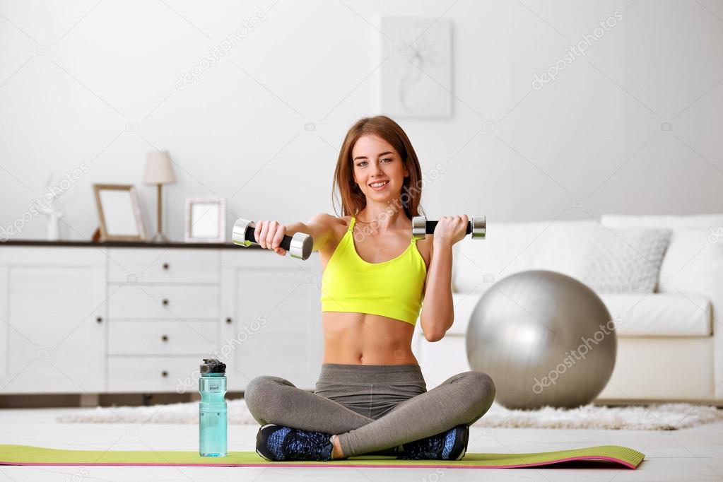 girl doing exercises with dumbbells