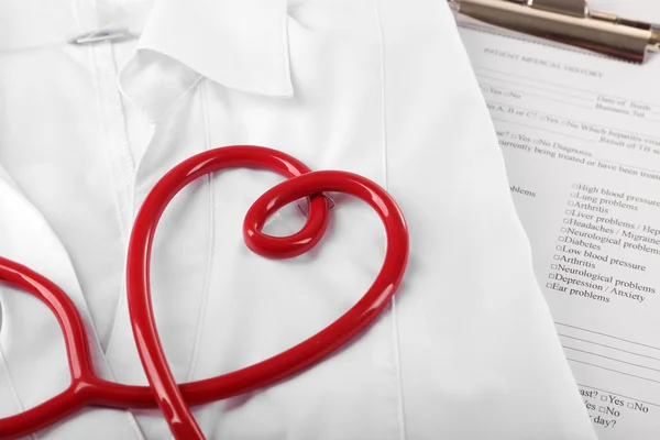 Red stethoscope, medical record and uniform