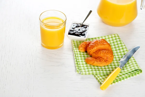 Tasty croissant and orange juice