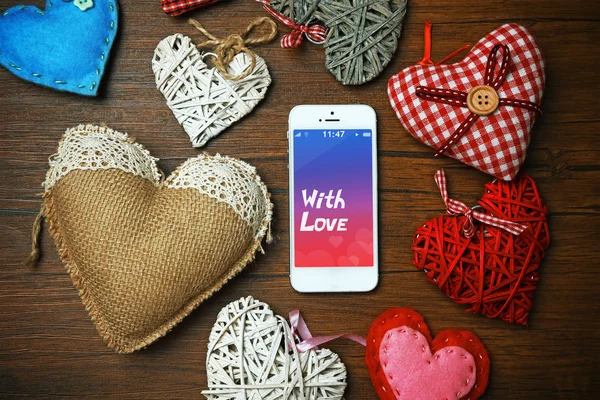 White smart phone with hearts — Stock Photo, Image