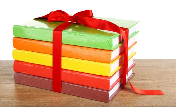 Stack of books with ribbon on light background — Stock Photo, Image