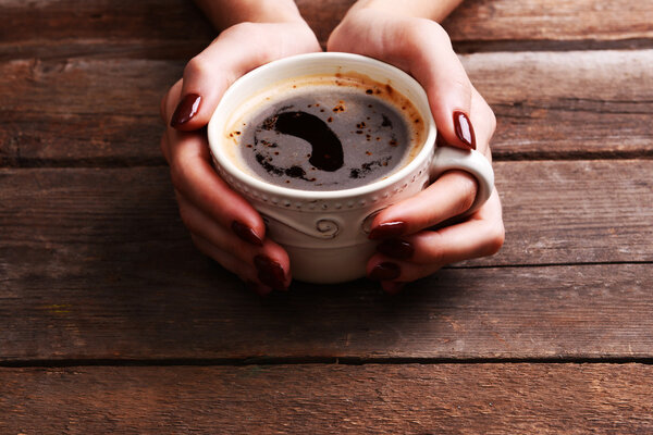 Female hands holding cup