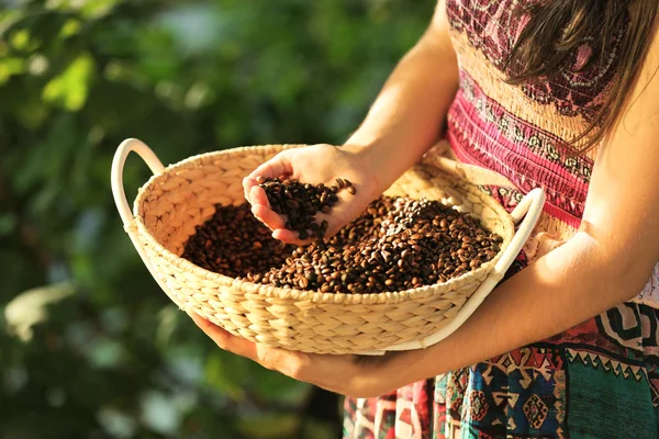 Female hand touching coffee beans — Stock Photo, Image