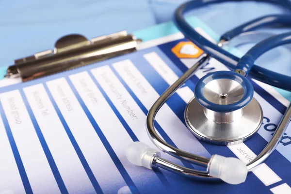 Medical stethoscope and clipboard — Stock Photo, Image