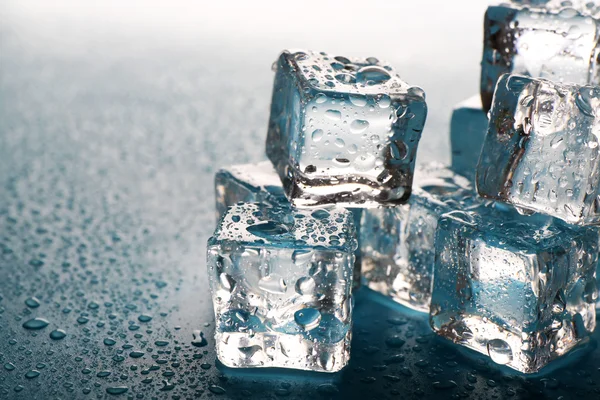 Melting ice cubes with drops around, close up Stock Picture