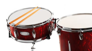Red drums with drum sticks isolated on white background clipart