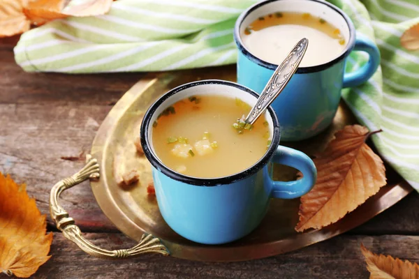 Two mugs of soup on a metal tray — Stock Photo, Image