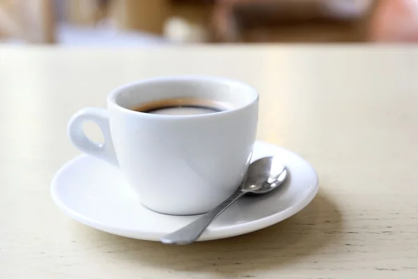 Taza de sabroso café con cuchara en la cafetería — Foto de Stock